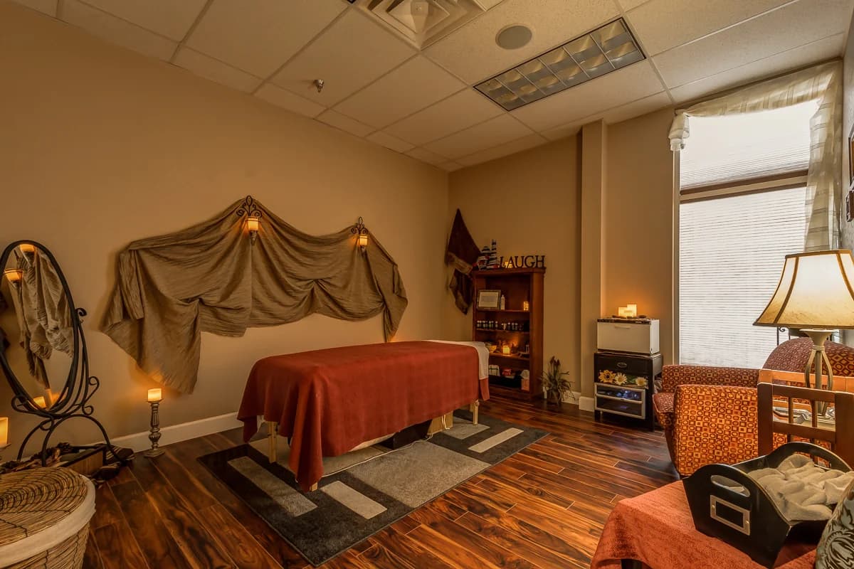 Massage room with a treatment table and soft lighting