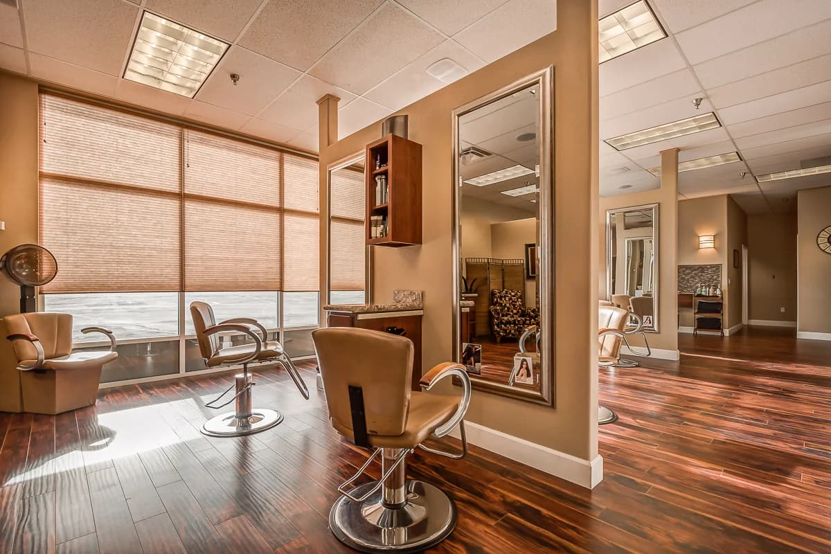 Styling chairs and mirrors beside the salon windows